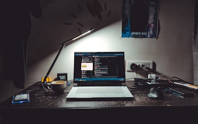 Professional reviewing resume on laptop with ATS optimization checklist